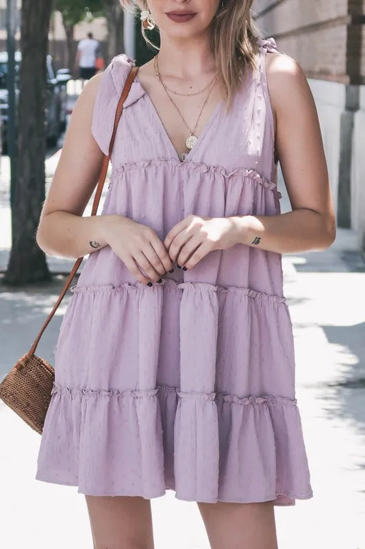Lavender polka dot textured layered flounce ruffle dress by Trendsi, featuring ruffled details and a playful, feminine design.