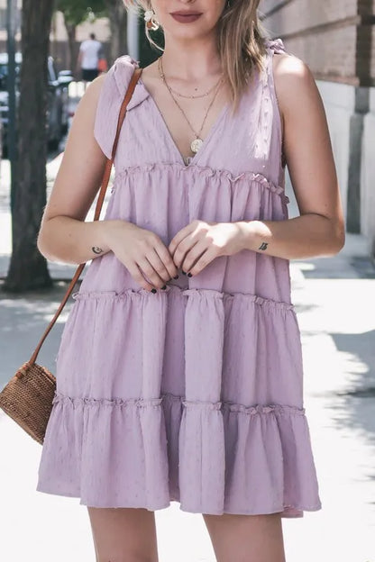 Lavender polka dot textured layered flounce ruffle dress by Trendsi, featuring ruffled details and a playful, feminine design.