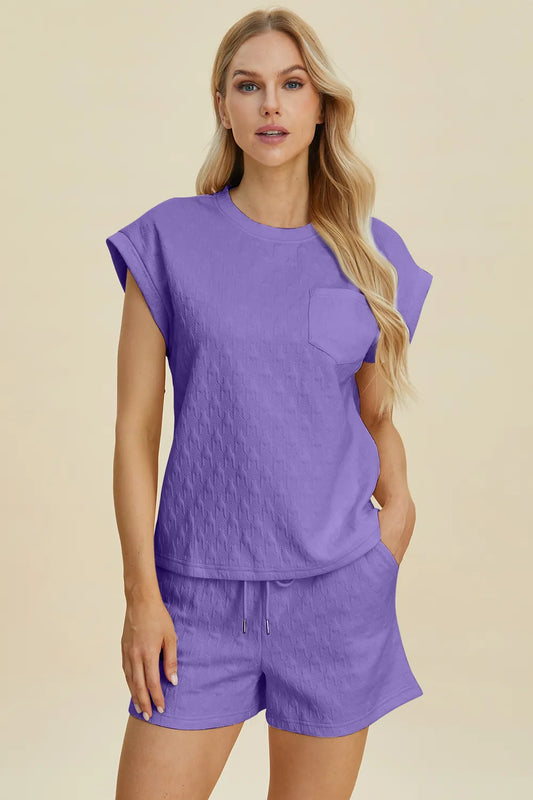 Lavender double take full size pocketed texture round neck top and shorts set by Trendsi, casual loungewear ensemble.