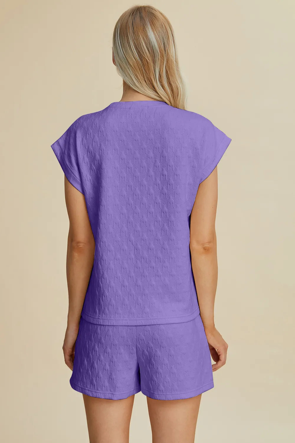 Lavender double take full-size pocketed textured round neck top and shorts set by Trendsi, casual and comfortable summer outfit.