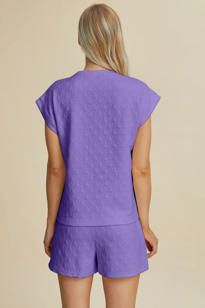 Lavender double take full-size pocketed textured round neck top and shorts set by Trendsi, casual and comfortable summer outfit.