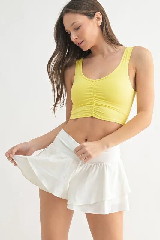 Trendsi MONO B ruched front active tank top in lemon color, lightweight athletic wear for women, with a fitted design and sleeveless style.