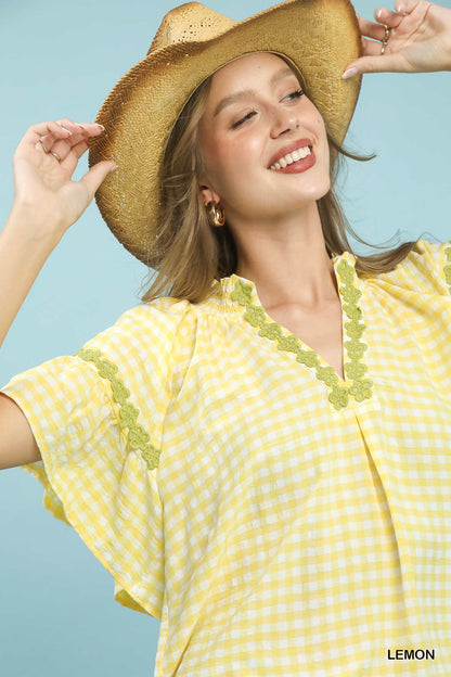 Lemon-colored Umgee Gingham Lace Trim Top with short sleeves and delicate lace details, stylish and lightweight for casual wear.