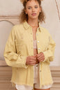 Trendsi lemon-colored button-down shacket with raw hem and distressed details, casual long-sleeve outerwear for layered style.