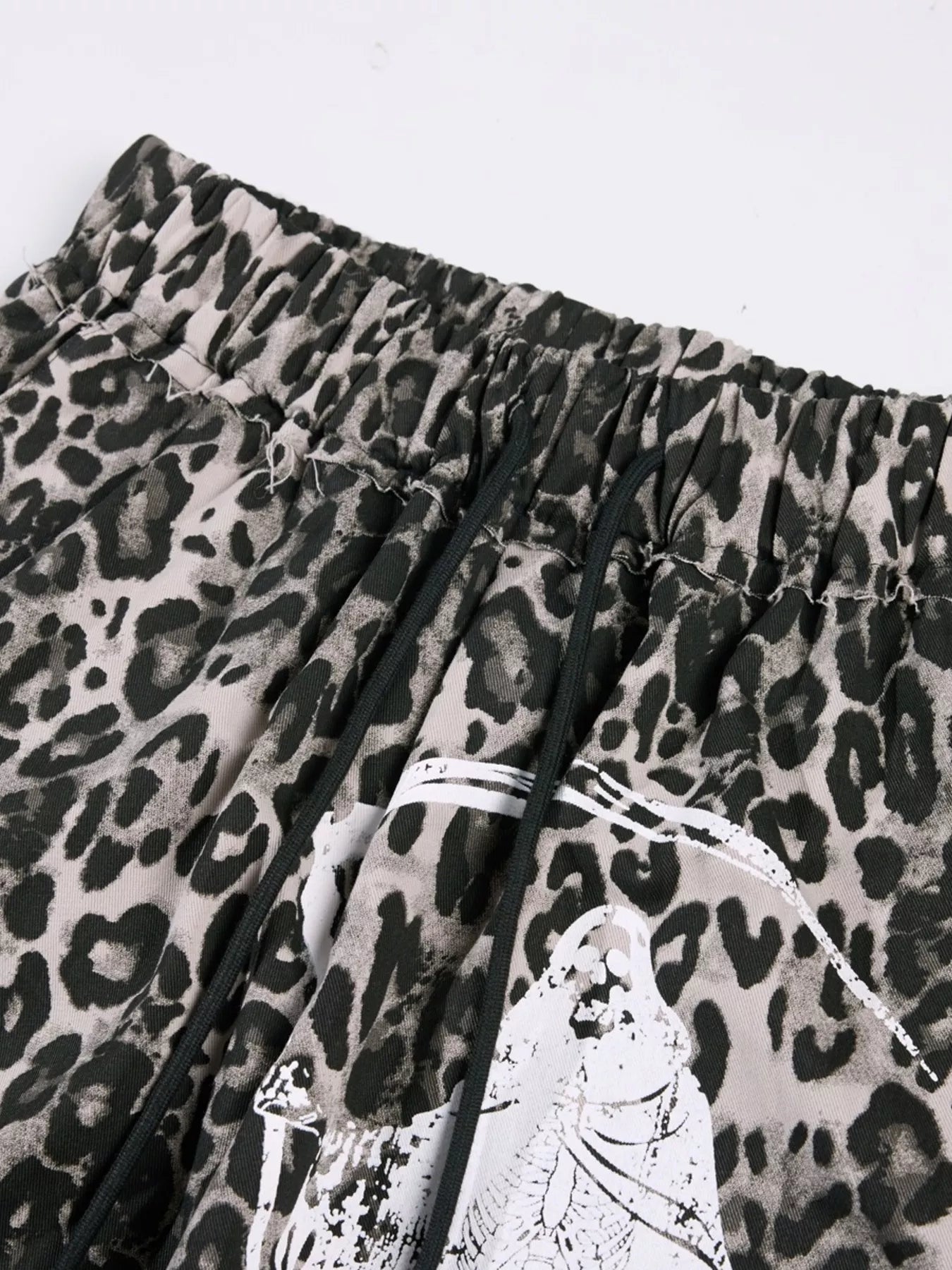 Men's leopard print wide-leg pants by Trendsi, featuring a bold leopard pattern, relaxed fit, and stylish wide silhouette.