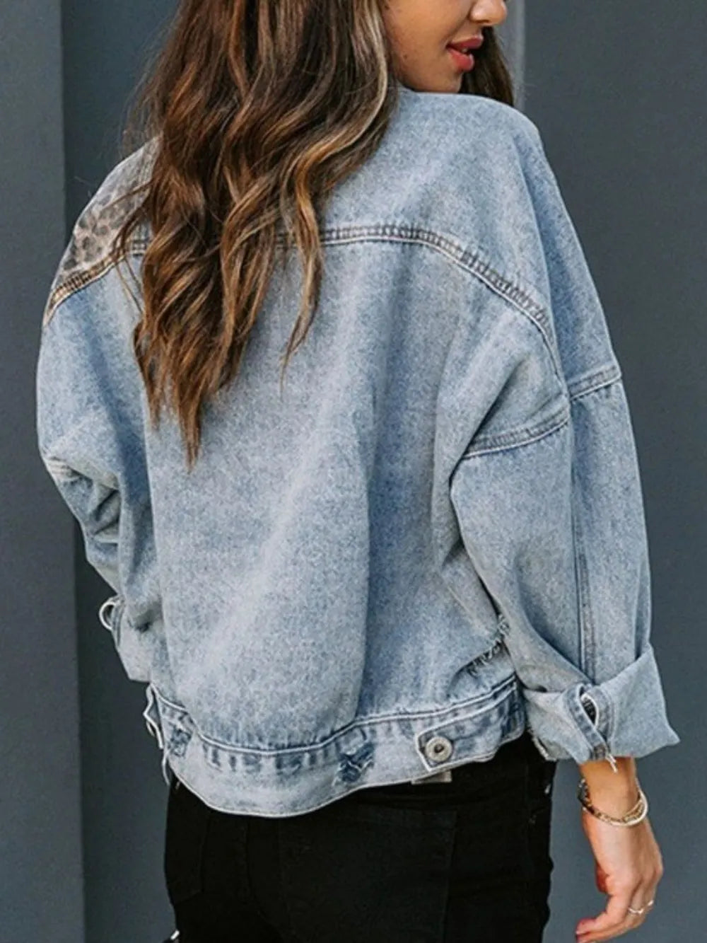 Distressed leopard print drop shoulder denim jacket by Trendsi with frayed edges and relaxed fit, stylish and casual outerwear.