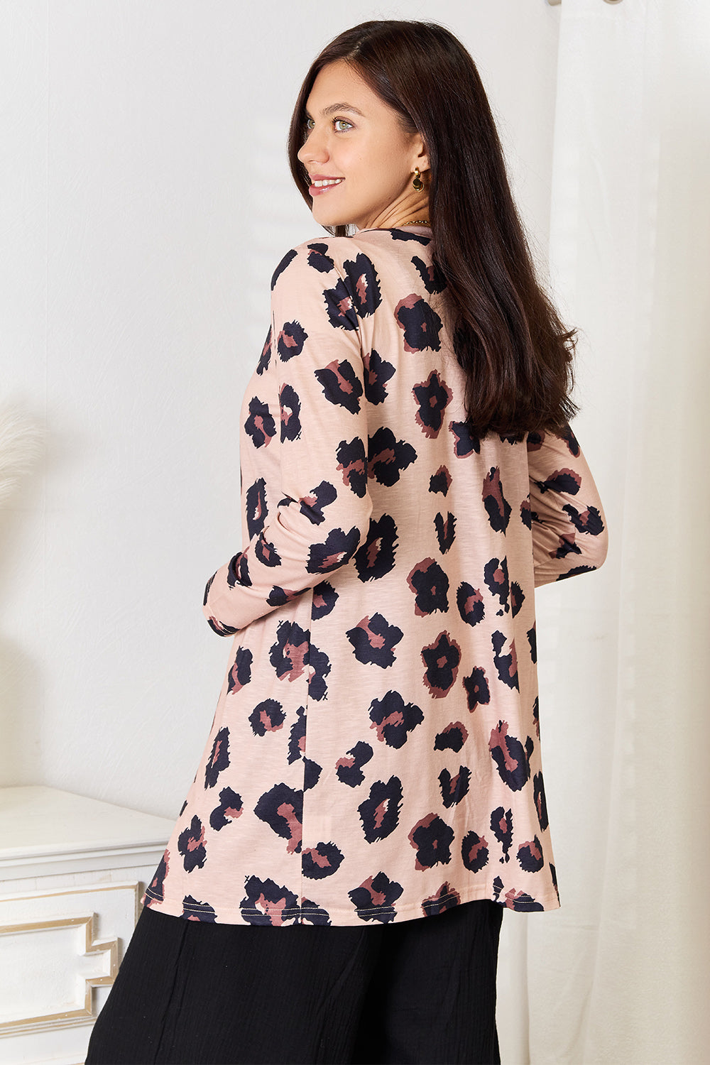Leopard print Trendsi Double Take printed button-front longline cardigan displayed on a model, showcasing its relaxed fit and stylish design.
