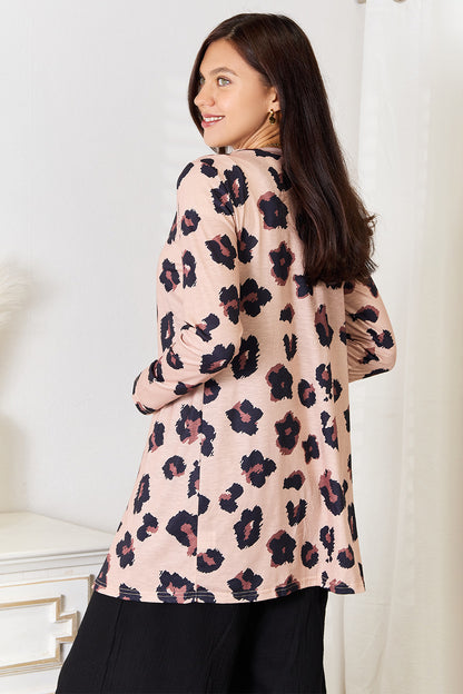 Leopard print Trendsi Double Take printed button-front longline cardigan displayed on a model, showcasing its relaxed fit and stylish design.