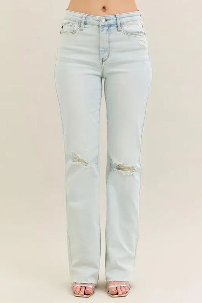Plus size Judy Blue destroy and fray hem bootcut jeans with distressed details and classic fit, shown on a model.
