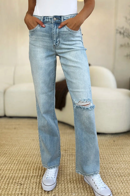 Light wash Judy Blue high waist distressed straight jeans with frayed hems and ripped details, displayed on a model.