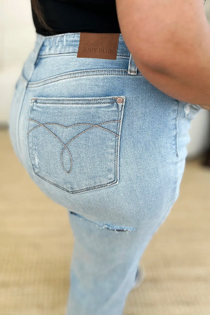 Light wash Judy Blue high waist distressed straight jeans with frayed details and classic fit, perfect for casual wear.