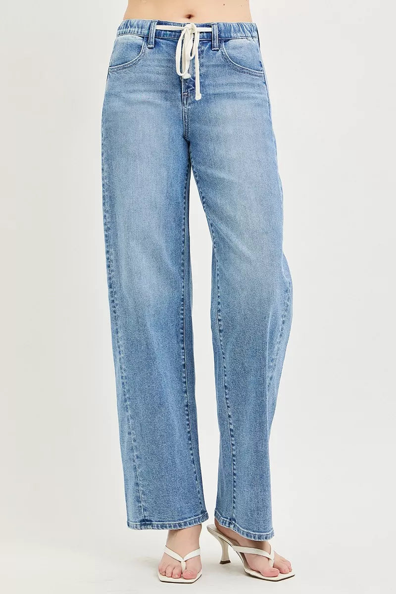 Light blue RISEN relaxed fit jeans with drawstring waist, featuring classic denim texture and casual style.