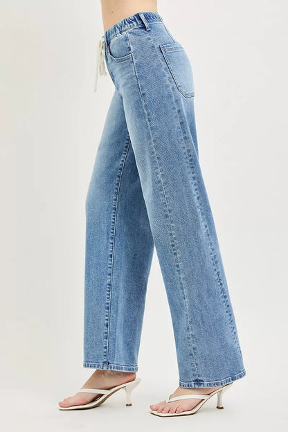 Light wash Risen relaxed fit drawstring waist jeans with front pockets, casual style, shown on a model.