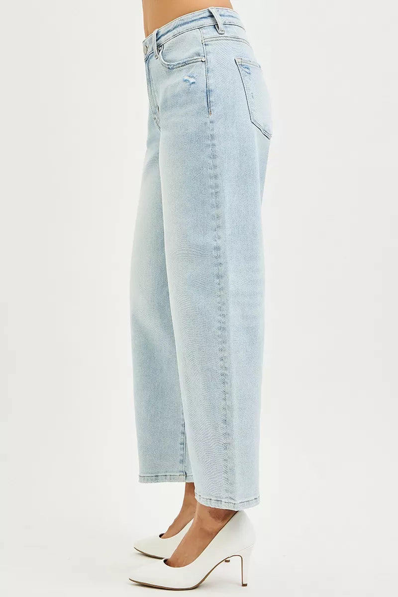 Light blue Risen high-rise crop barrel jeans by Trendsi, shown on a model with a relaxed fit and stylish design.