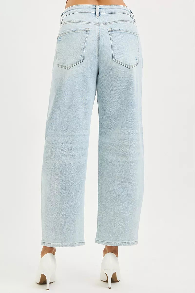 Light blue Risen high-rise crop barrel jeans from Trendsi, featuring a fitted waist, relaxed legs, and classic denim texture.