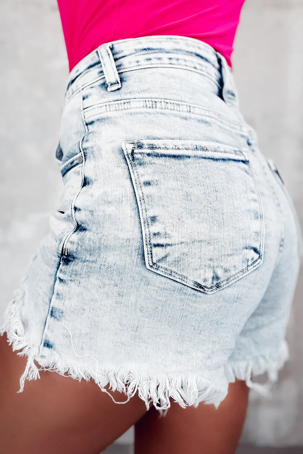 Light wash raw hem buttoned denim shorts with front and back pockets from Trendsi, casual summer denim shorts.