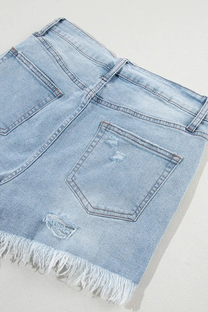 Light blue distressed raw hem high waist denim shorts by Trendsi, featuring frayed edges and classic fit.