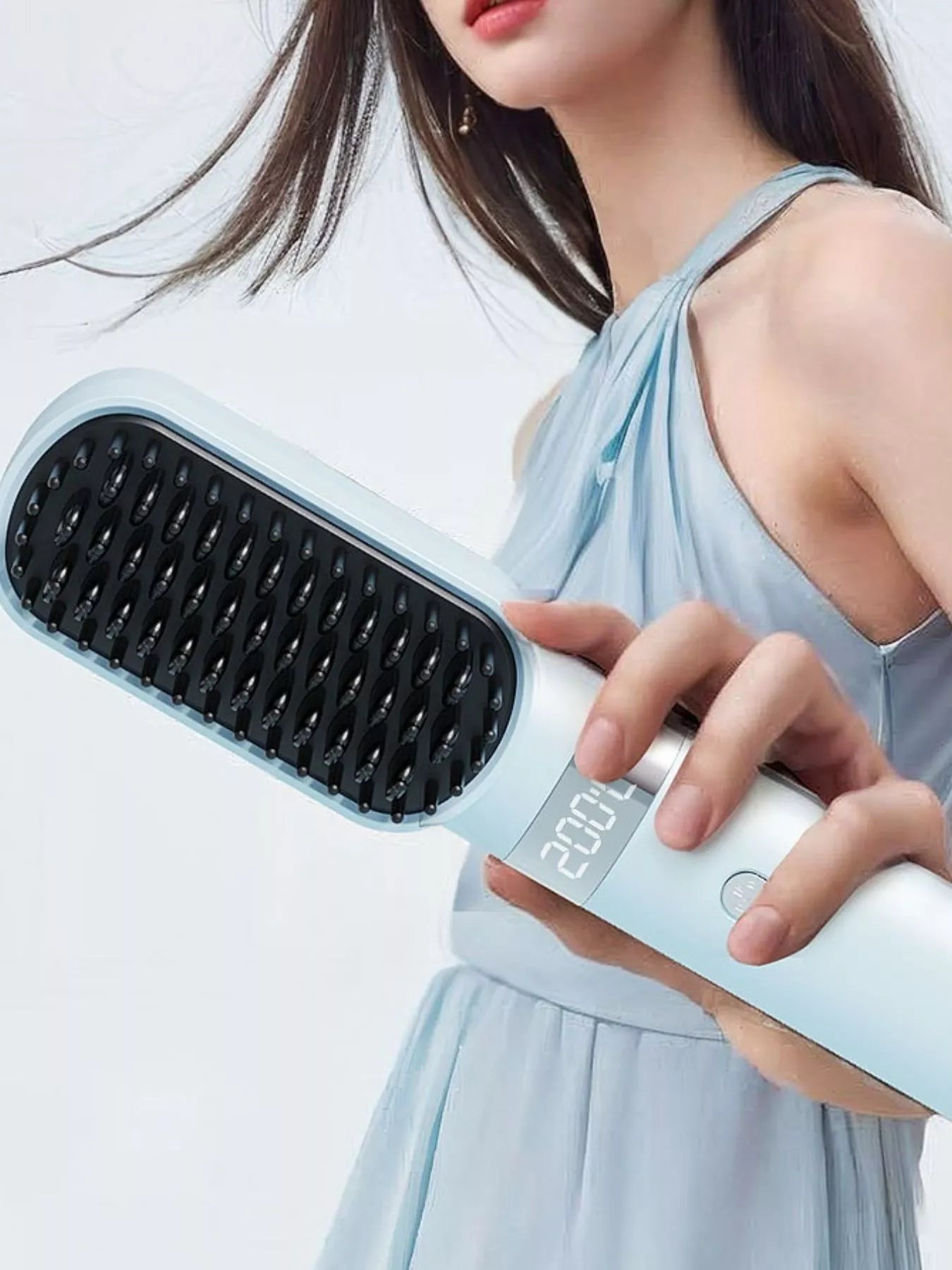 Light blue 2-in-1 portable wireless ionic brush straightener comb by Trendsi for quick, easy hair styling at home or on the go.