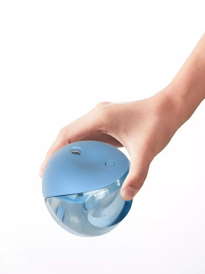 Light blue apple-shaped humidifier by Trendsi with a sleek design and visible mist output on a plain background.