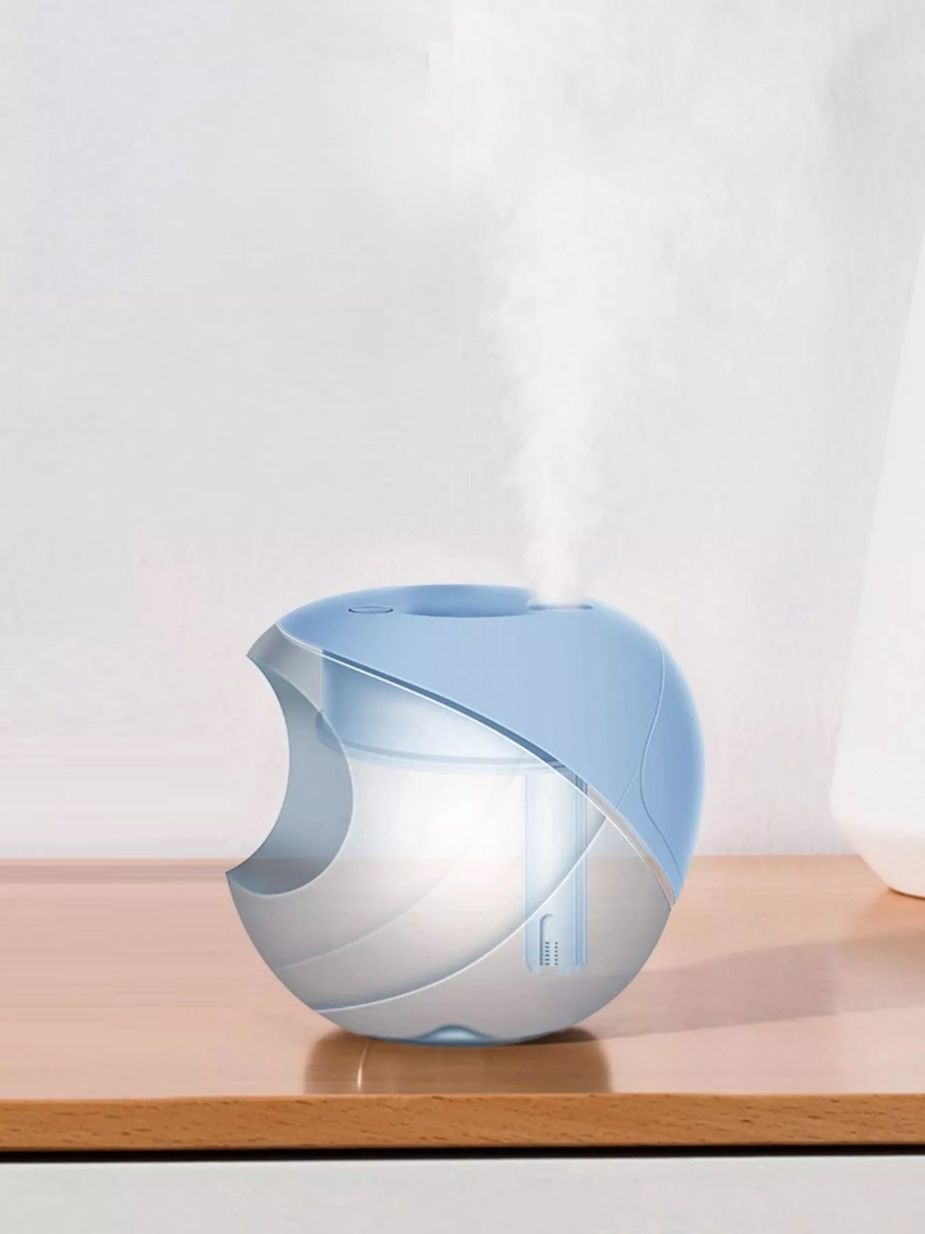 Light blue apple-shaped humidifier from Trendsi, showing its compact design and smooth, rounded shape in a natural setting.
