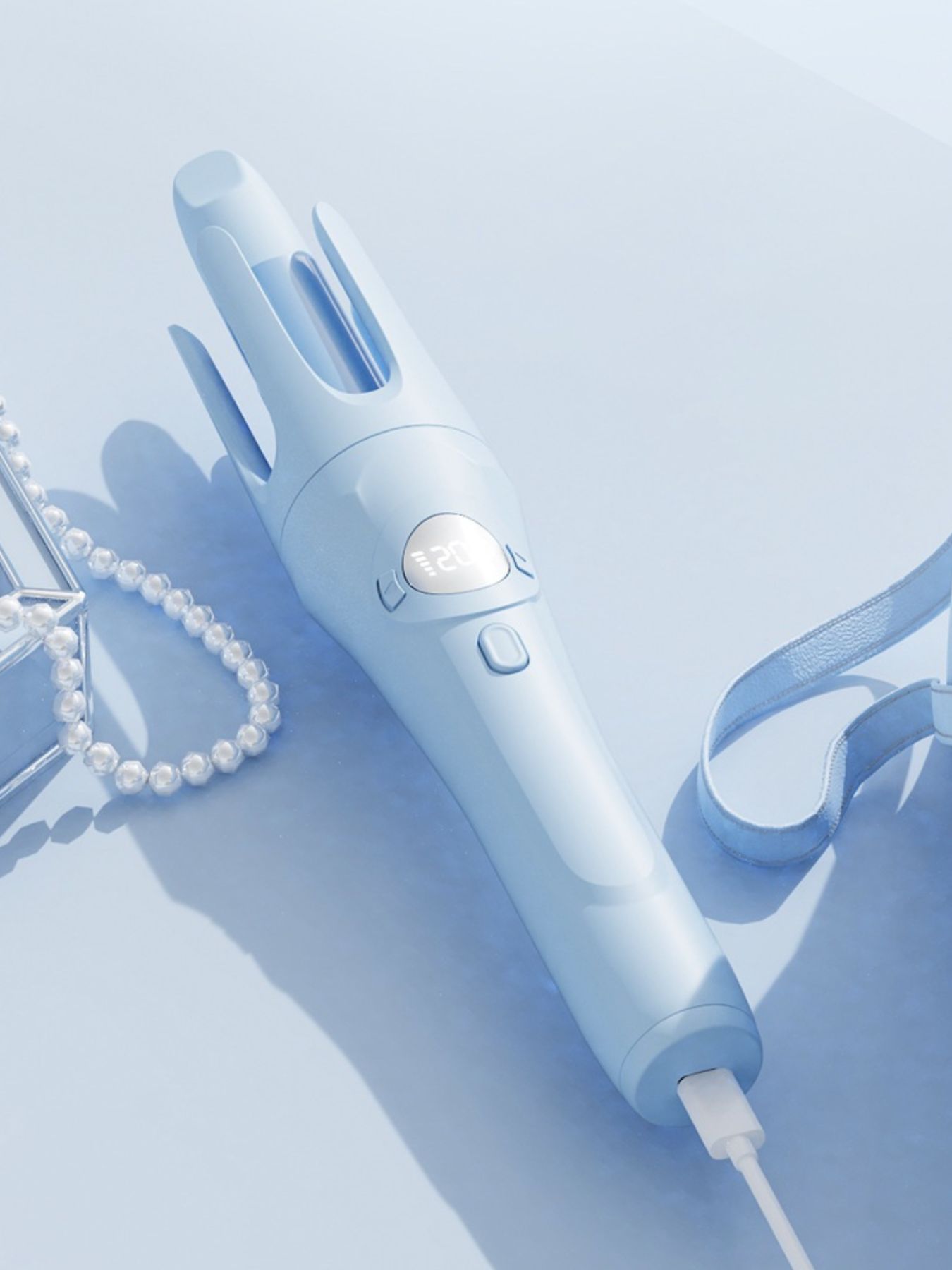 Light blue rotating ceramic hair curling iron from Trendsi with adjustable temperature and ergonomic handle.