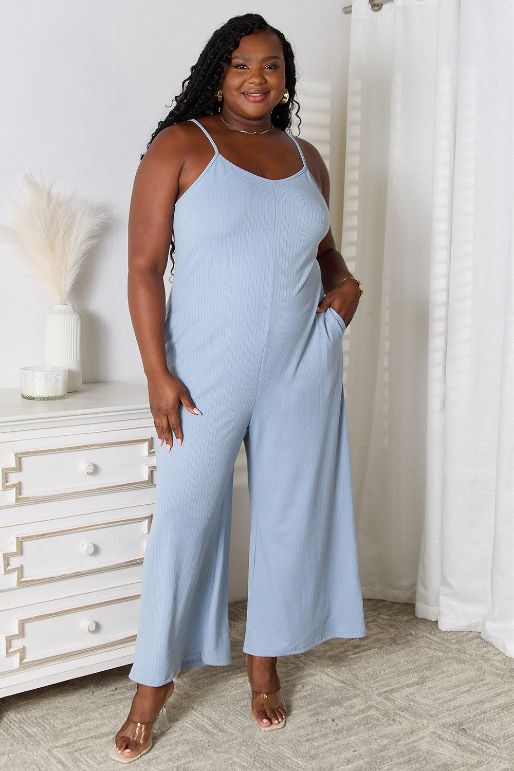 Light blue Trendsi Basic Bae full-size spaghetti strap V-neck jumpsuit laid flat for display.