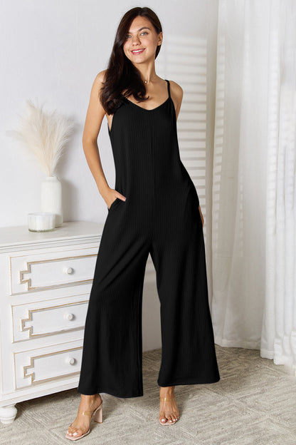 Light blue Basic Bae full-size spaghetti strap V-neck jumpsuit by Trendsi, displayed on a hanger with adjustable straps.