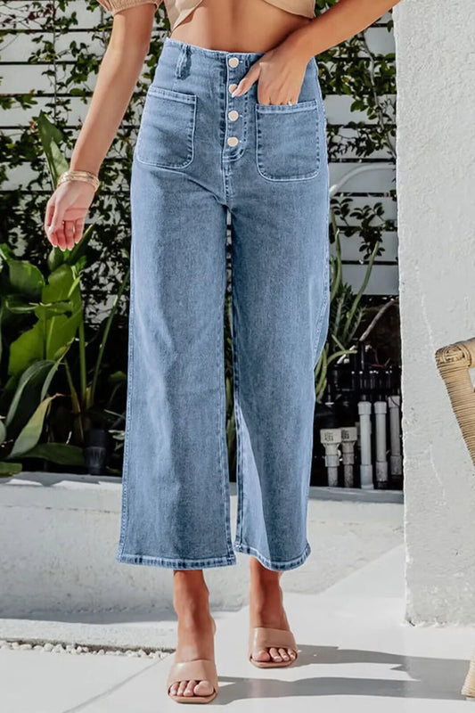 Light blue button fly cropped wide-leg jeans from Trendsi, showing high-waisted fit and relaxed style with visible stitching.