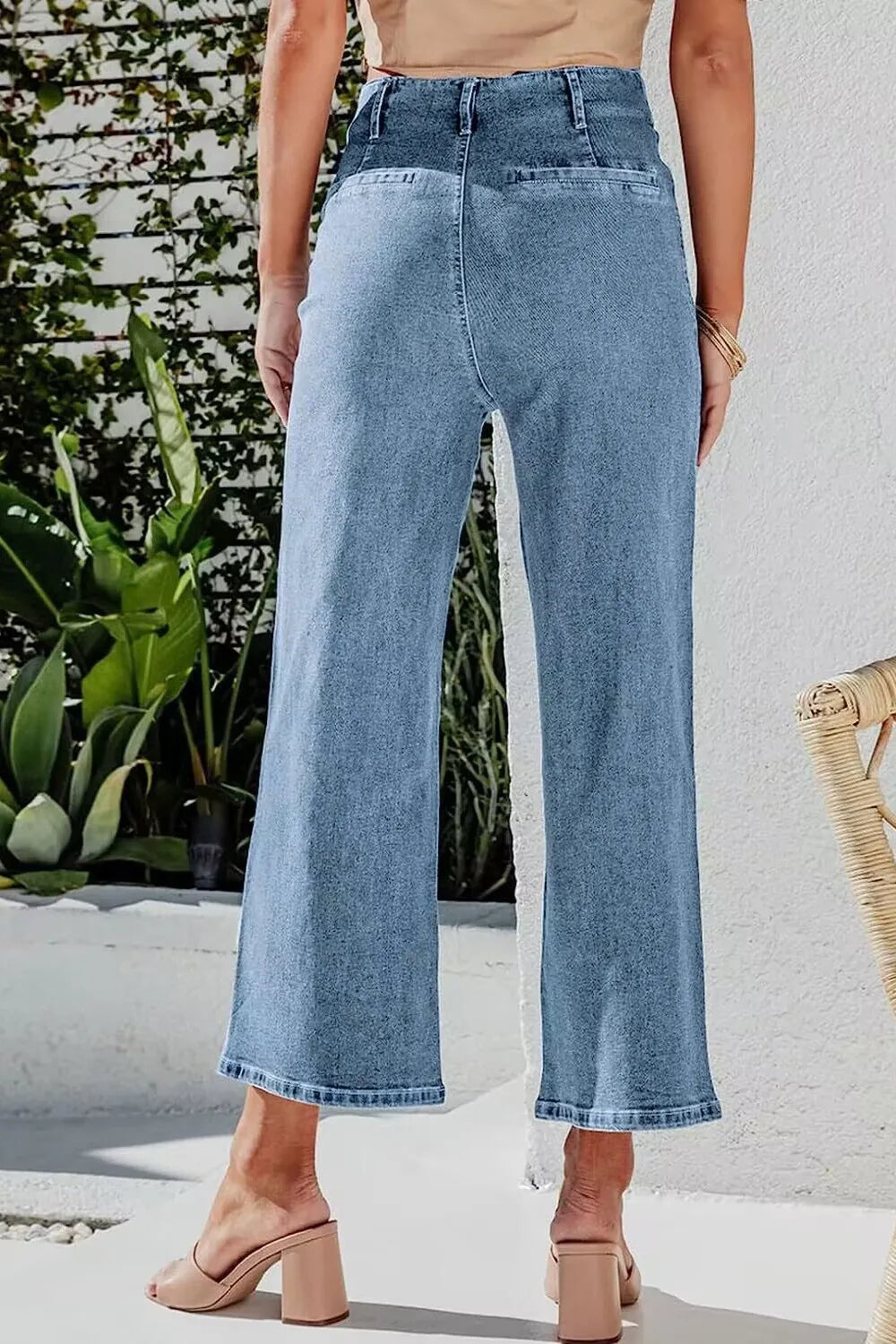 Light blue button fly cropped wide-leg jeans from Trendsi with a relaxed fit and high waist, shown on a model.