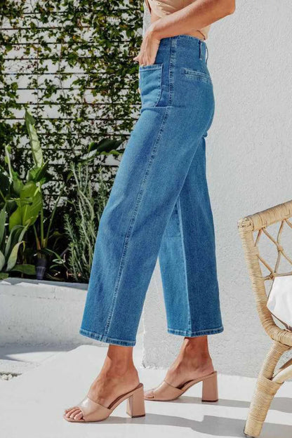 Light blue button fly cropped wide-leg jeans by Trendsi, showing the relaxed fit and stylish design on a model.