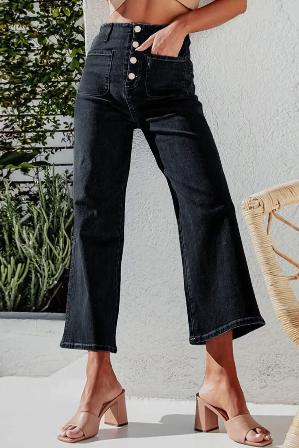 Light blue button fly cropped wide-leg jeans from Trendsi, featuring a relaxed fit and high-rise style with visible stitching.
