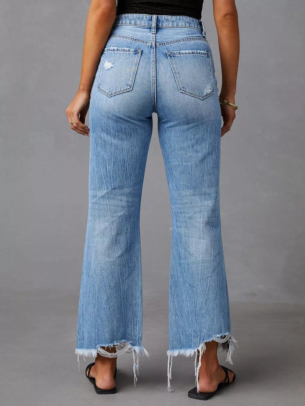 Light blue distressed raw hem jeans with pockets from Trendsi, featuring a casual fit and stylish, worn-in look.