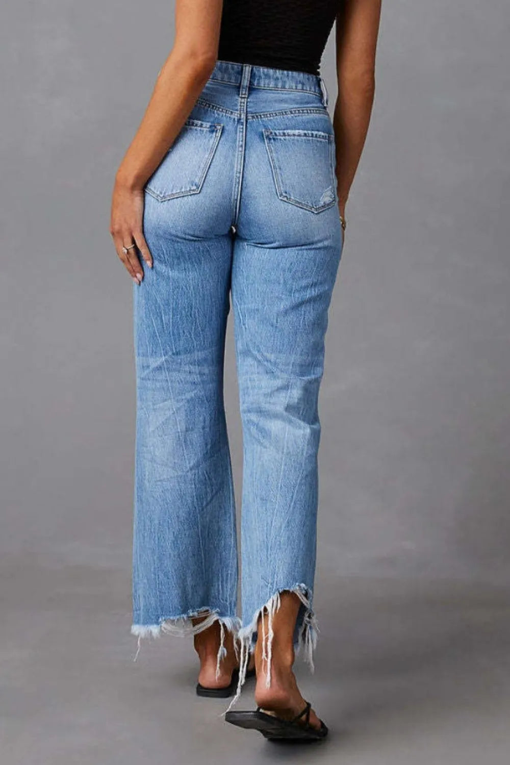 Light blue distressed raw hem jeans with pockets from Trendsi, featuring a casual, worn-in look and classic denim style.