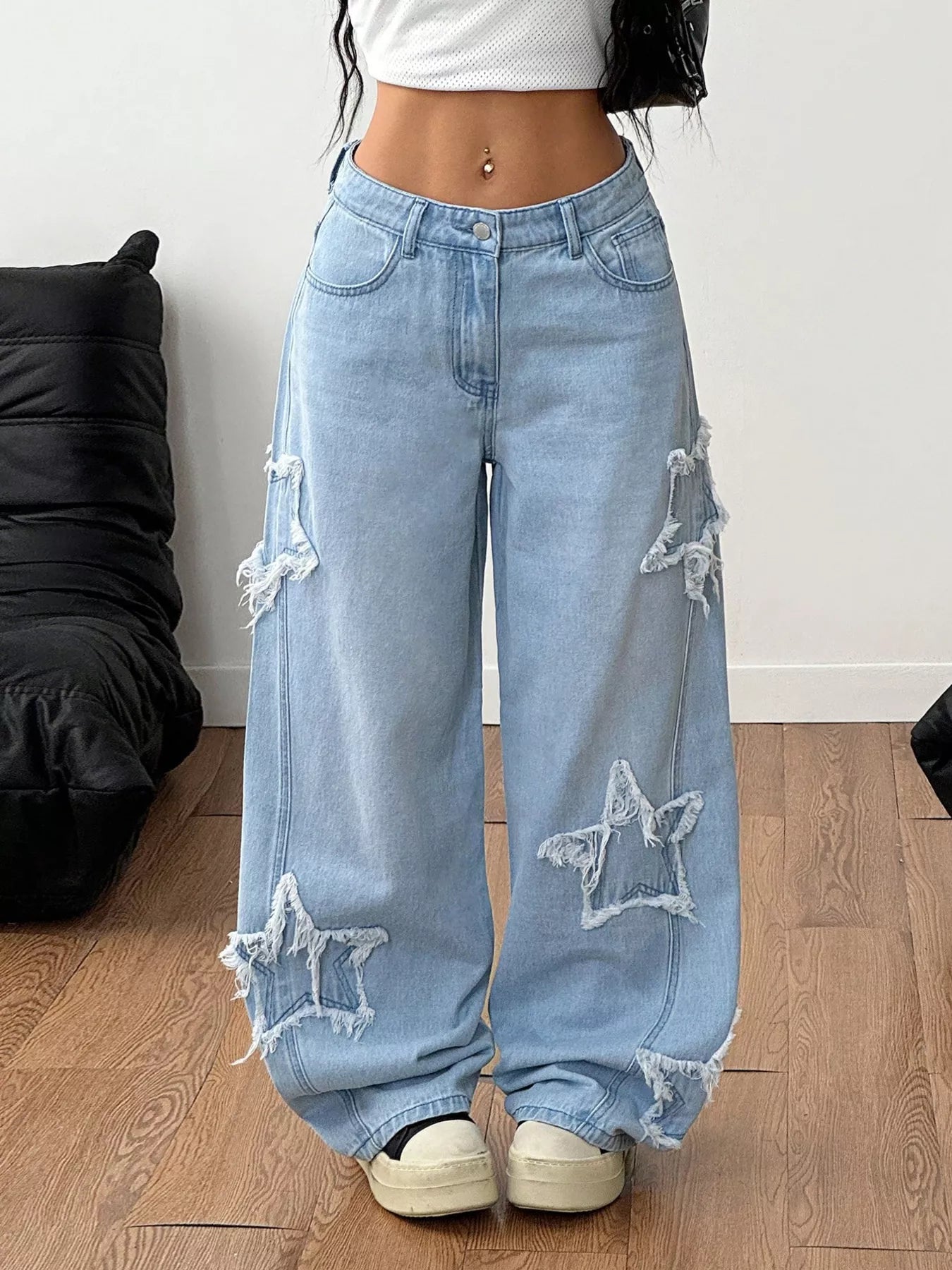 Light blue distressed star patch wide-leg jeans from Trendsi showing the relaxed fit, front patch details, and casual style.
