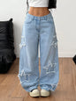 Light blue distressed star patch wide-leg jeans from Trendsi showing the relaxed fit, front patch details, and casual style.