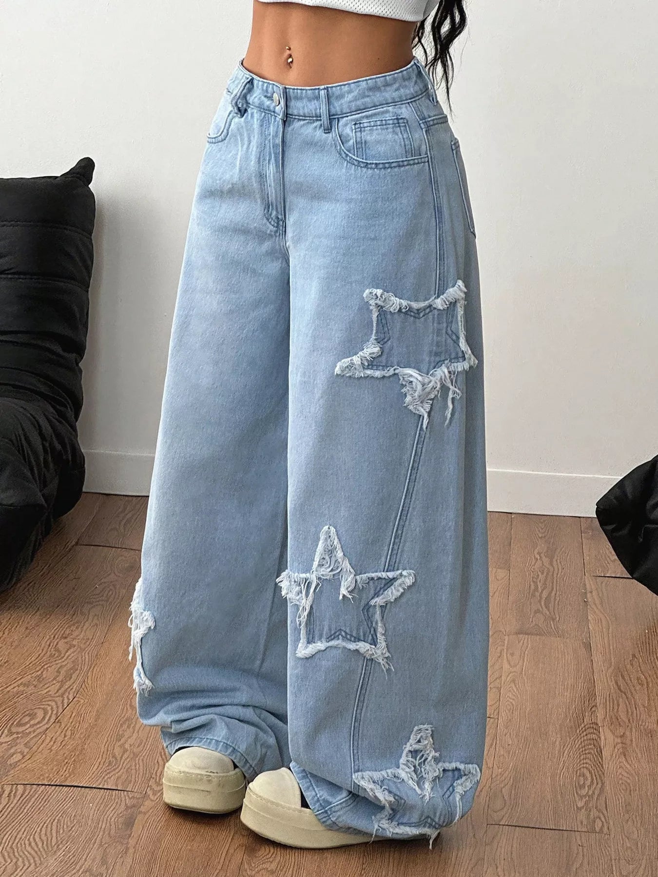 Light blue distressed star patch wide-leg jeans from Trendsi with ripped details and relaxed fit.