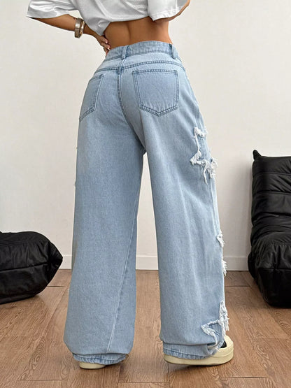 Light blue distressed star patch wide-leg jeans from Trendsi, featuring a relaxed fit and trendy distressed detailing.