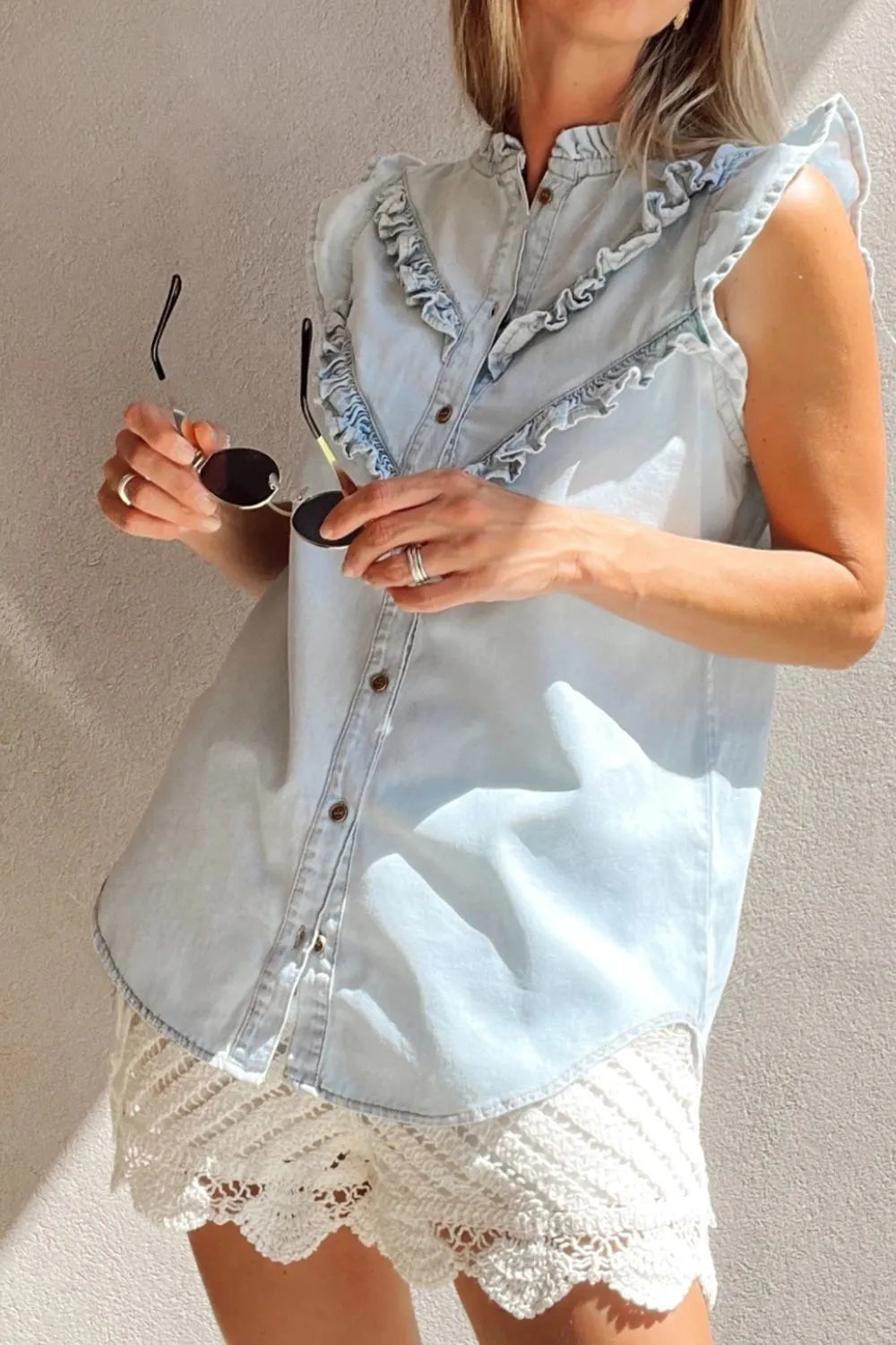 Light blue denim top with frill button-down front and ruffled cap sleeves, stylish and casual for trendy summer looks.