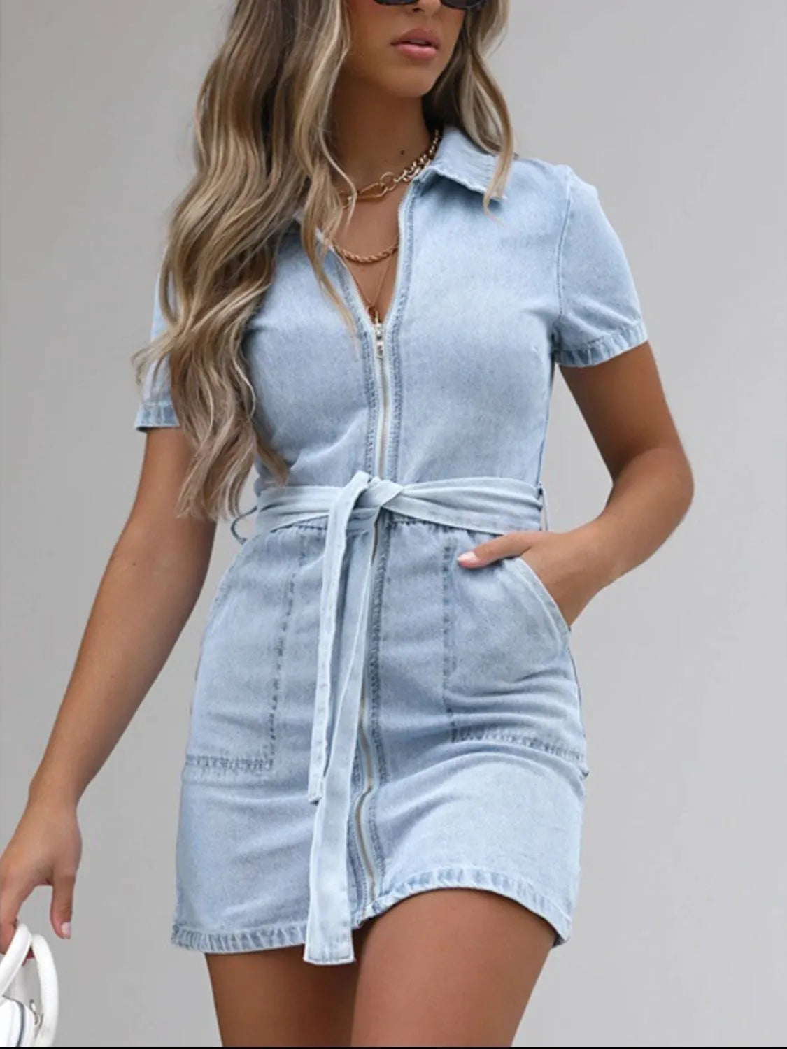 Light blue plus size denim dress with short sleeves and full front zipper, from Trendsi, shown on a model.