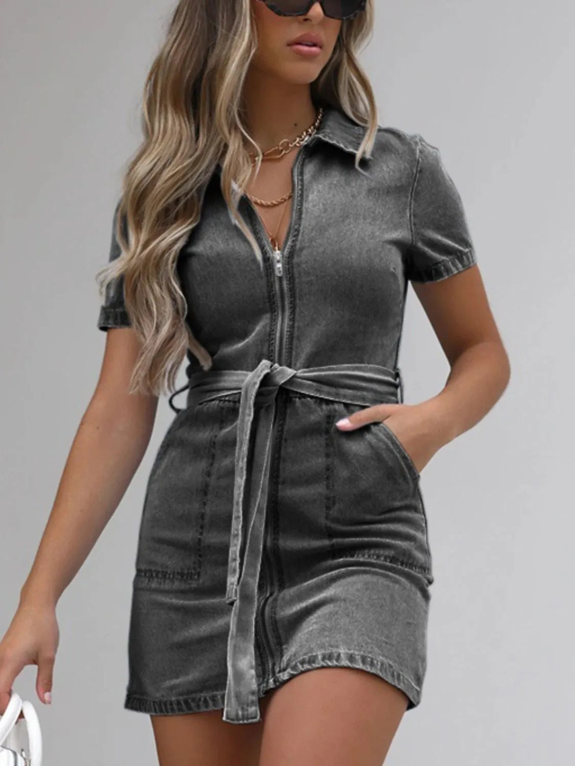 Light blue plus size denim dress with short sleeves and full front zipper by Trendsi, styled casually on a model.