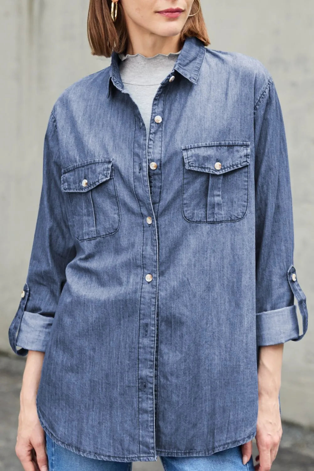 Light blue denim long sleeve top with pockets and a collared neck from Trendsi, showcasing casual style and button details.