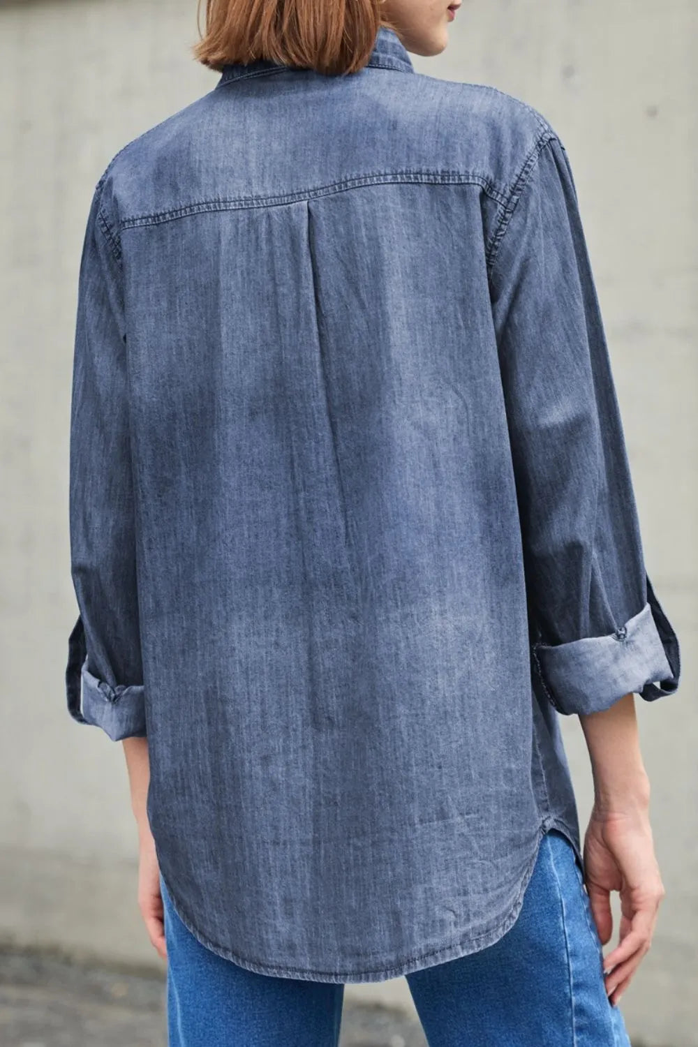 Light blue denim long sleeve top with collar and front pockets, by Trendsi, featuring a classic casual style.