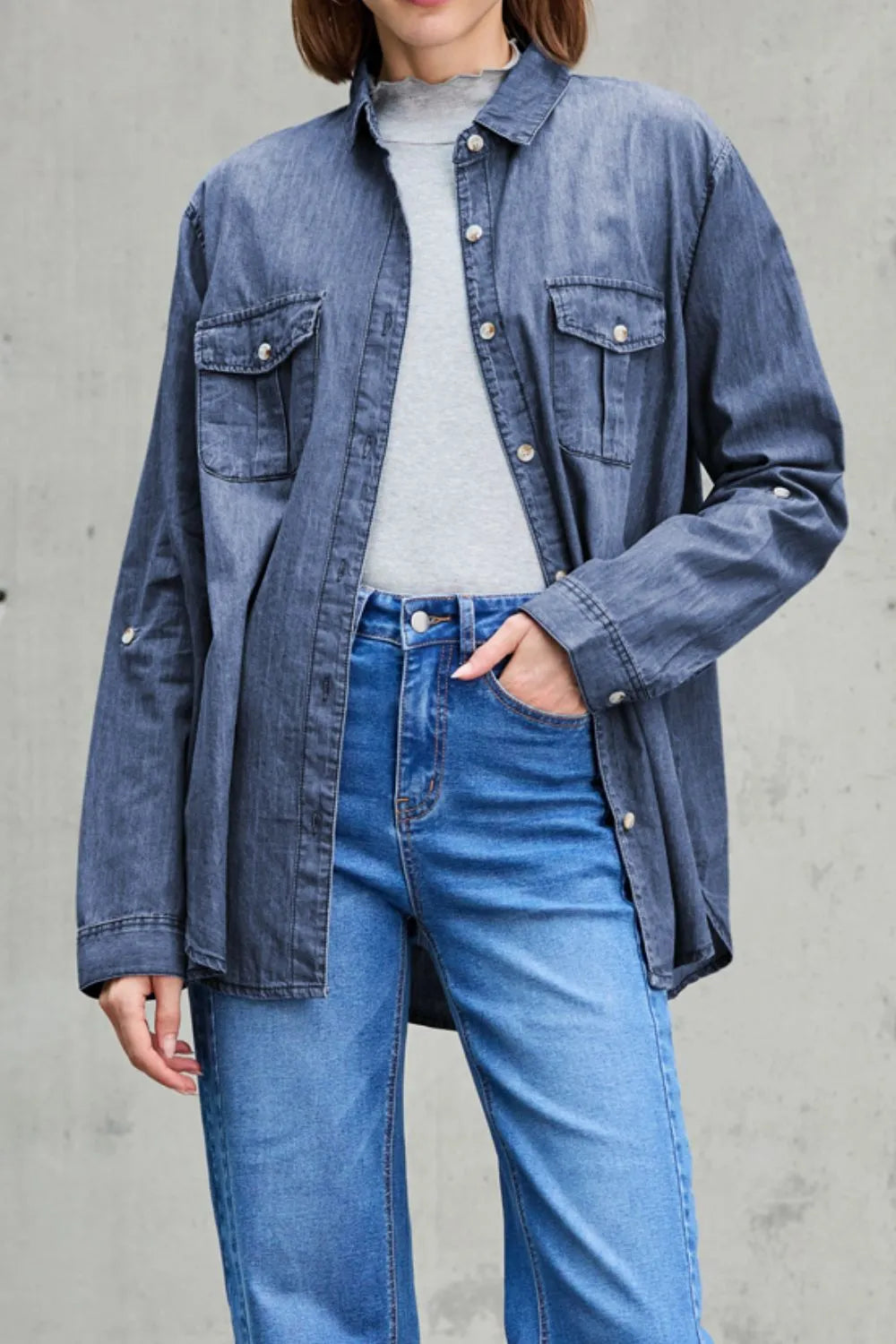 Light blue denim long sleeve top with chest pockets and collar, by Trendsi, featuring a casual, stylish design.