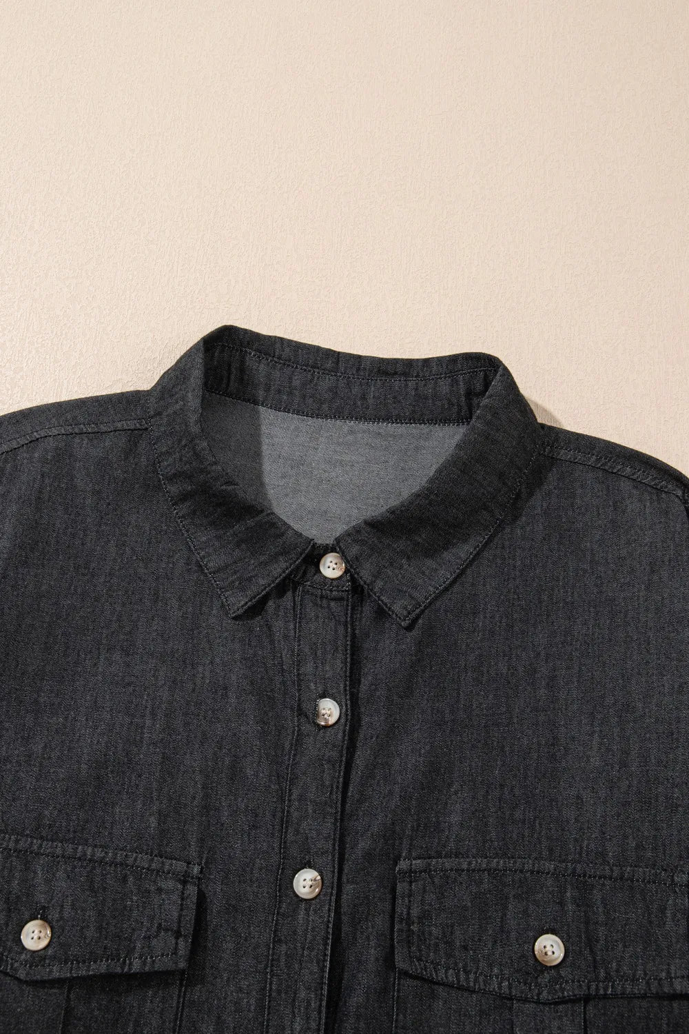 Light blue denim long sleeve top with a collared neck and front pockets, from Trendsi, showcasing its casual, stylish design.