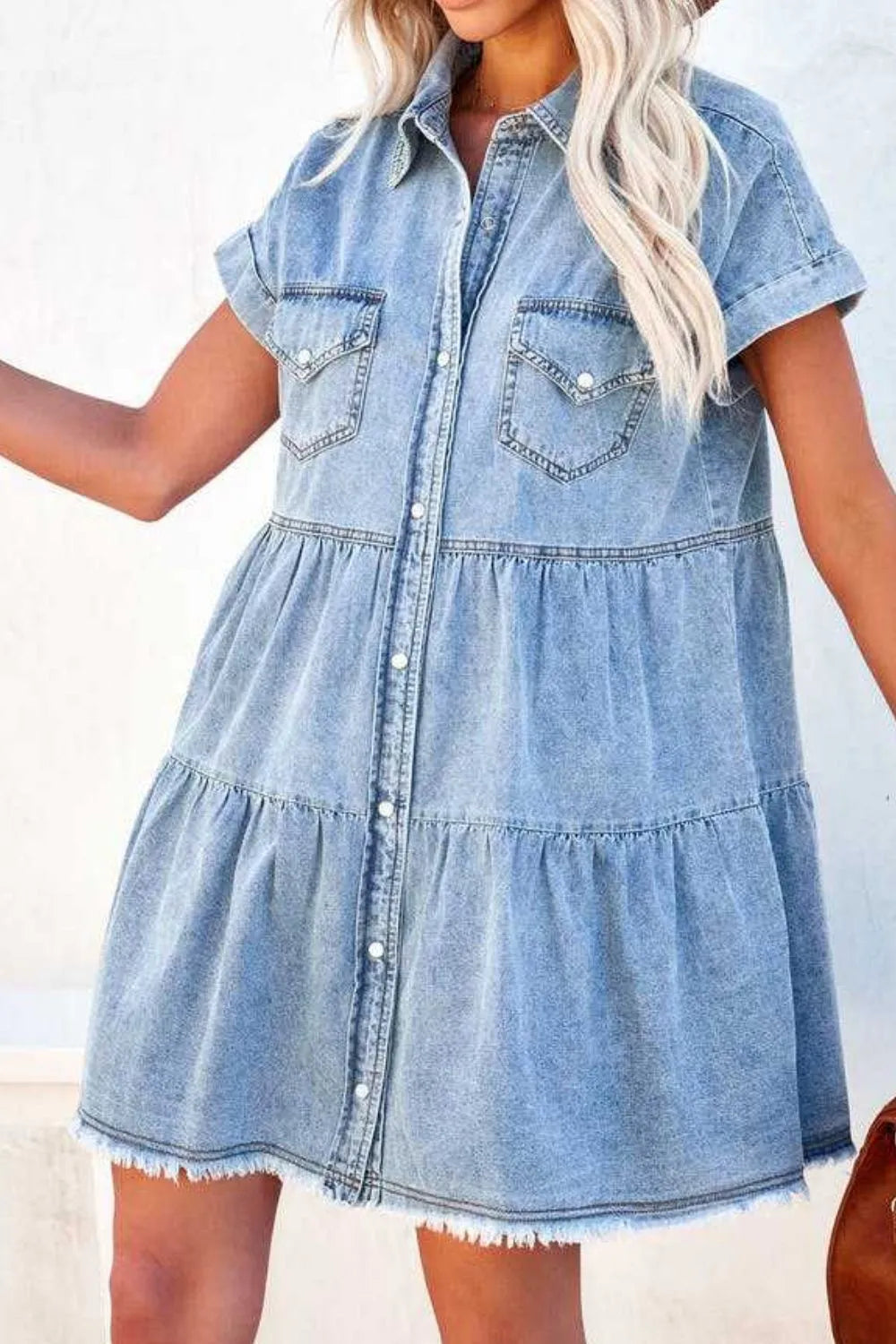 Light blue raw hem button-down denim mini dress by Trendsi, featuring a classic collar and front buttons on a casual style.