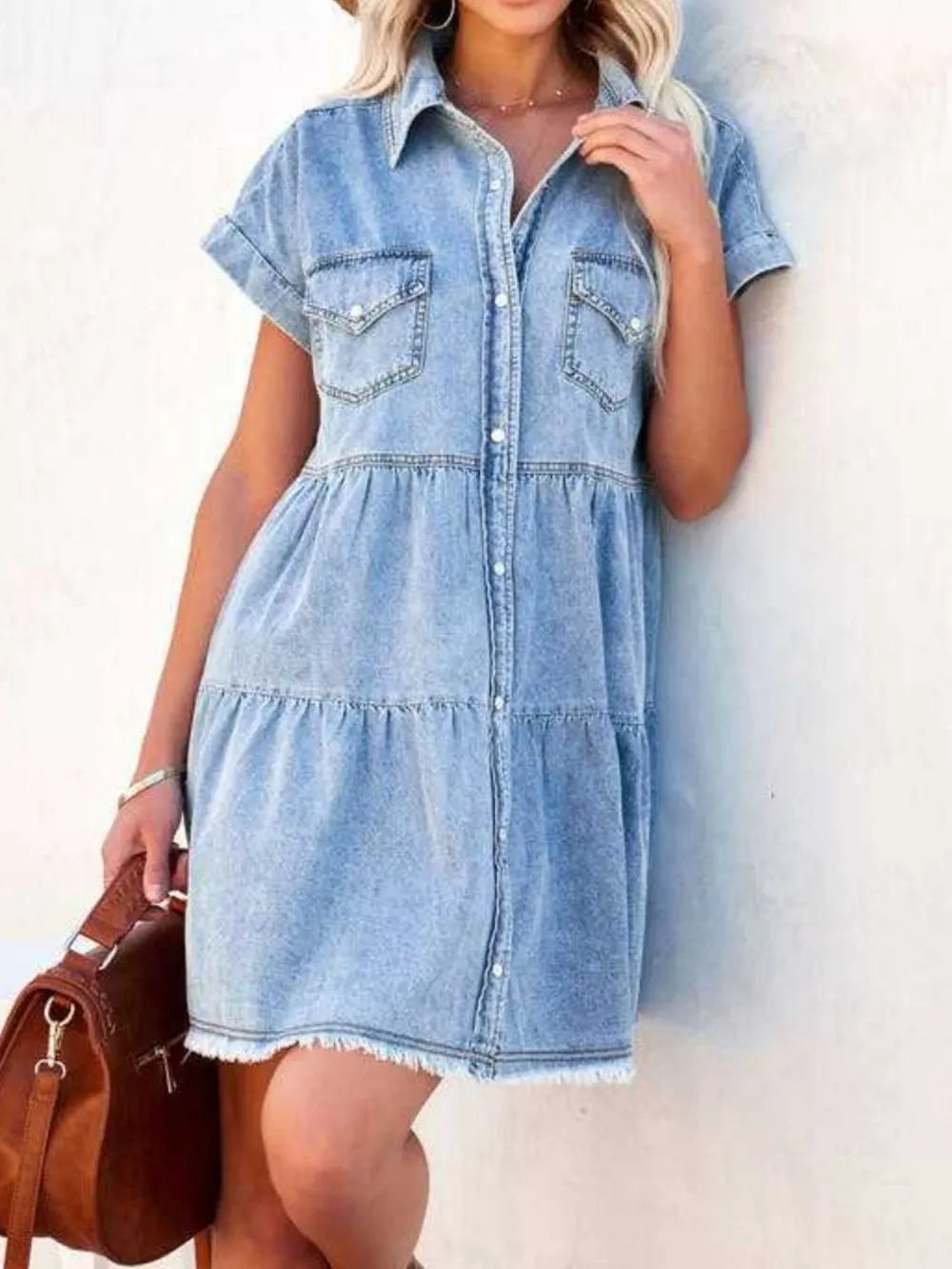 Light blue raw hem short sleeve denim dress by Trendsi, showcasing a casual fit with a classic denim texture and raw hem detail.