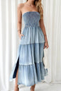 Light blue smocked tube denim dress with slit and tiered design, featuring trendy details perfect for casual or stylish occasions.