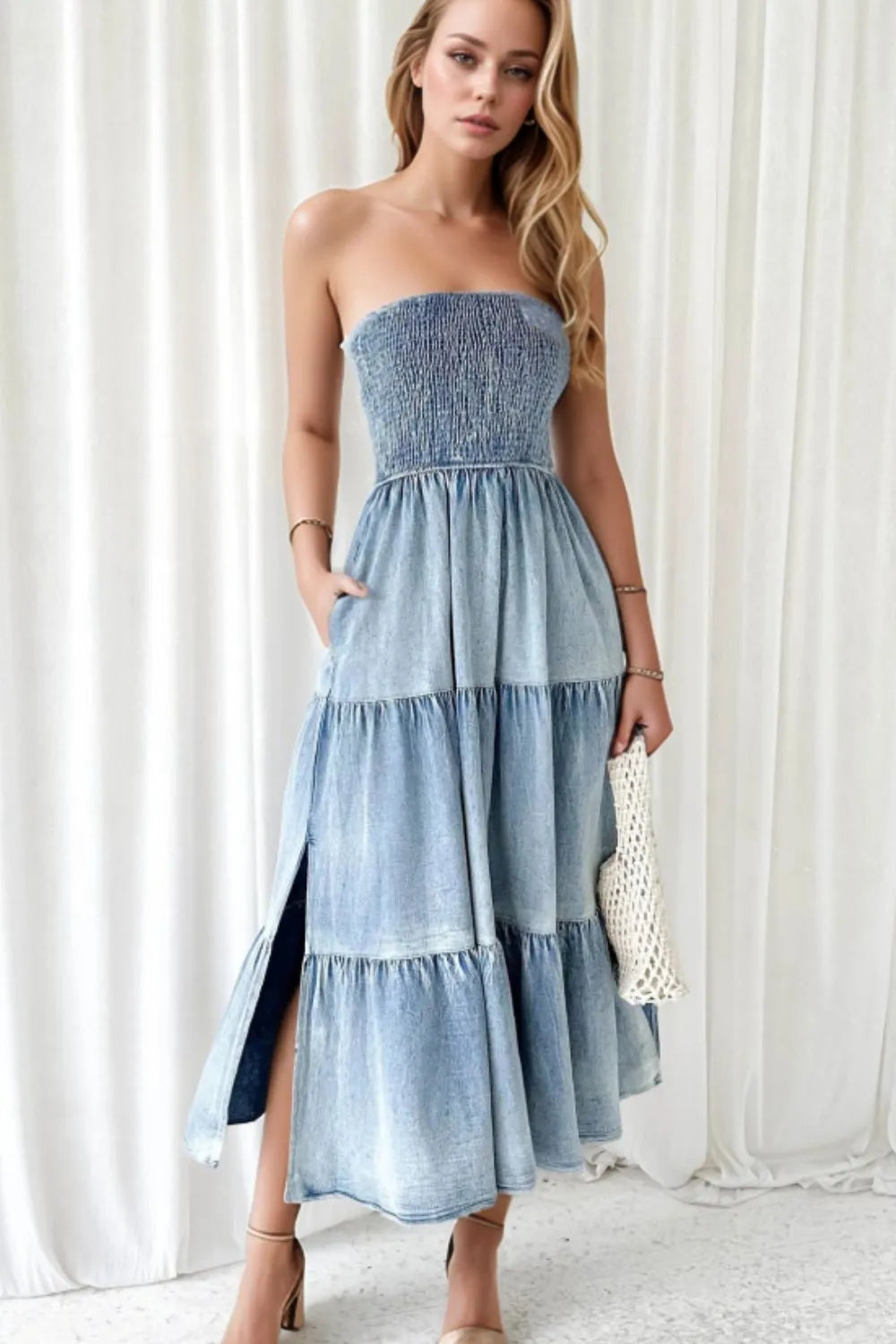 Light blue smocked tube denim dress with slit and tiered design, styled by Trendsi, shown on a model.