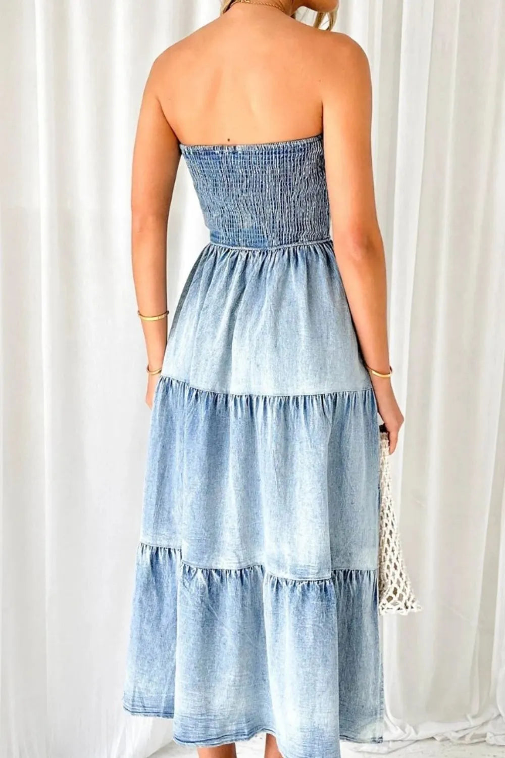 Light blue smocked tube denim dress with slit and tiered design from Trendsi, styled for casual or summer wear.