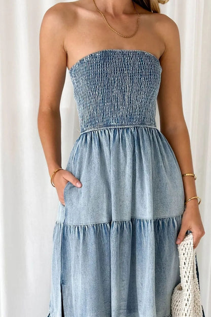 Light blue smocked tube denim dress with slit and tiered design by Trendsi, displayed on a model.